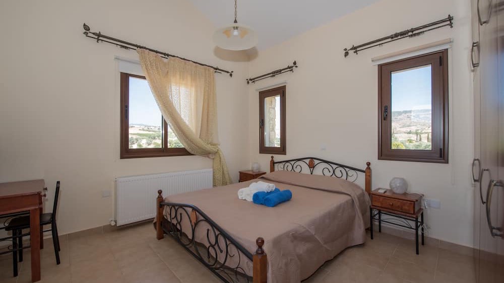 A second bedroom with windows looking out over the valley